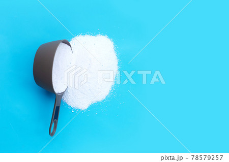 Detergent powder with measuring spoon for clothes washing. Laundry concept. Detergent powder with measuring spoon for clothes washing. Laundry concept. 78579257
