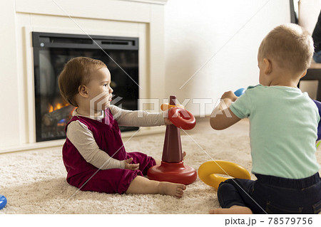 family, friends, friendship, childhood, development, skills, motility games - little authentic children toddler kids puts rings on pyramid playing together with toy sit on floor indoors at cozy home family, friends, friendship, childhood, development, skills, motility games - little authentic children toddler kids puts rings on pyramid playing together with toy sit on floor indoors at cozy home 78579756
