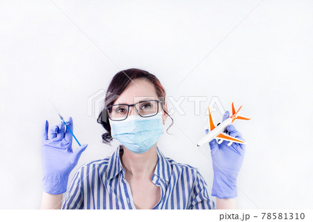 Nurse holding vaccine syringe and airplane model, vaccination against the virus covid-19. vaccination against covid-19 for traveling and vaccine passport 78581310