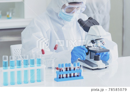 Male Scientist look into Microscope research in science laboratory. Asian scientist looking equipment laboratory chemistry labs. Covid-19 coronavirus biochemistry research experiment vaccine concept Male Scientist look into Microscope research in science laboratory. Asian scientist looking equipment laboratory chemistry labs. Covid-19 coronavirus biochemistry research experiment vaccine concept 78585079