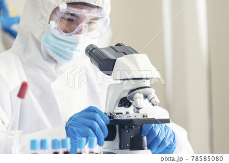 Male Scientist look into Microscope research in science laboratory. Asian scientist looking equipment laboratory chemistry labs. Covid-19 coronavirus biochemistry research experiment vaccine concept Male Scientist look into Microscope research in science laboratory. Asian scientist looking equipment laboratory chemistry labs. Covid-19 coronavirus biochemistry research experiment vaccine concept 78585080