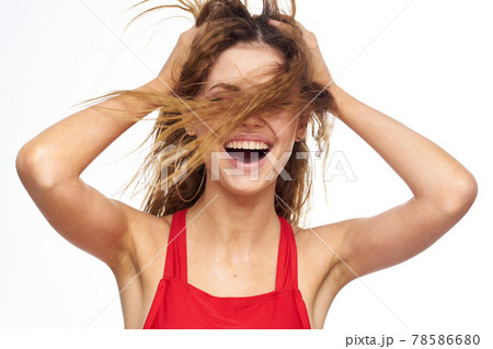Pretty woman red tank top wavy hair attractive look hotel lifestyle light background 78586680