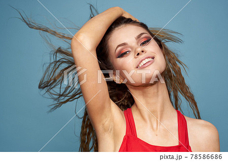 Attractive woman wavy hair charming look cosmetics elegant style blue background Attractive woman wavy hair charming look cosmetics elegant style blue background 78586686