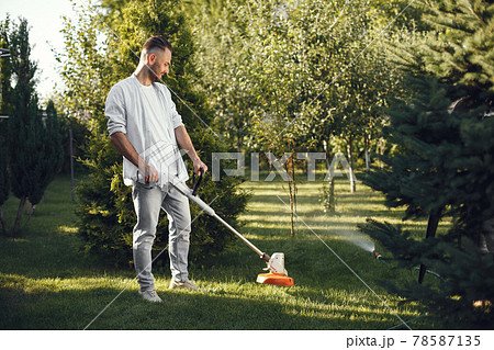 Lawn mower man working on the backyard 78587135