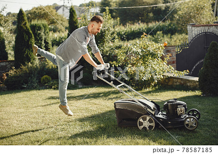 Lawn mower man working on the backyard 78587185