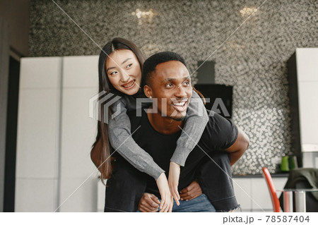 Happy couple have fun in their new apartment Happy couple have fun in their new apartment 78587404