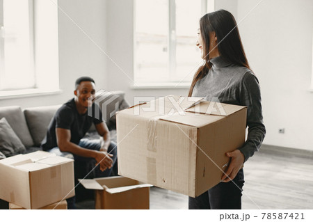 Couple unpacking boxes at their new home Couple unpacking boxes at their new home 78587421