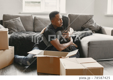Asian wife and black man hugging in their flat Asian wife and black man hugging in their flat 78587425