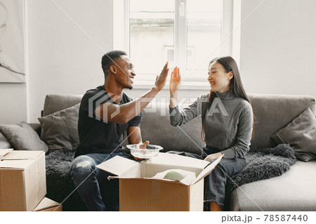 Couple unpacking boxes at their new home Couple unpacking boxes at their new home 78587440