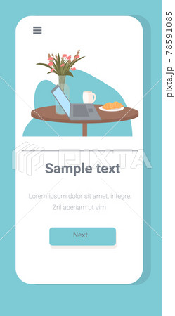 laptop flowers coffee cup and croissant on table work from home self-isolation concept 78591085