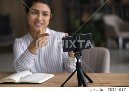 Active young indian female shoot motivational training on cell webcam 78594017