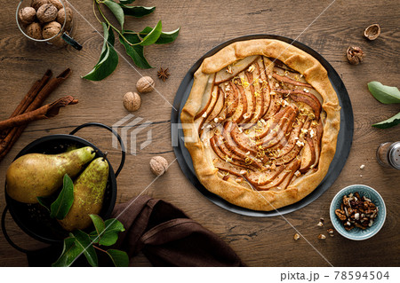 Pear galette with walnuts, cinnamon and lemon zest, autumn fruit pie with nuts Pear galette with walnuts, cinnamon and lemon zest, autumn fruit pie with nuts 78594504