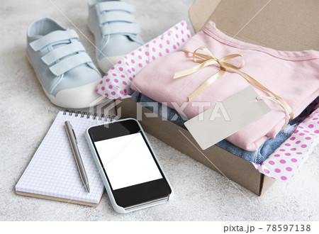 Clothes fir kids in an open cardboard box 78597138