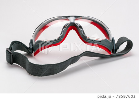 Red frame working goggles with black elastic strap on white background. Red frame working goggles with black elastic strap on white background. 78597603