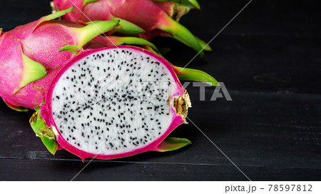 Fresh dragon fruit on a black wooden table. Fresh dragon fruit on a black wooden table. 78597812