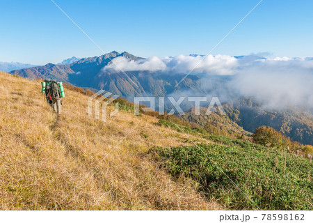 Hikers walk in the mountains at sunset. 78598162