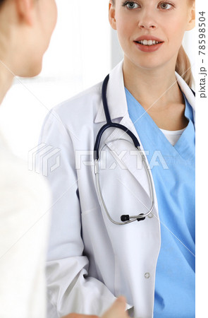 Woman - doctor consults her female patient in sunny clinic Woman - doctor consults her female patient in sunny clinic 78598504