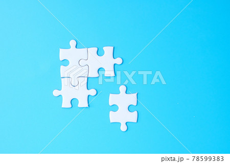 Group of white puzzle jigsaw pieces on blue background. Concept of solutions, mission, success, goals, cooperation, partnership, strategy and puzzle day 78599383