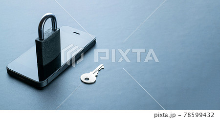 Mobile security. Modern space grey mobile phone with padlock, key on dark background. Identity theft and cyber security concept. 78599432