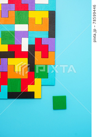 colorful wood puzzle pieces on blue background, geometric shape block. Concepts of logical thinking, Conundrum, solutions, rational, strategy, world logic day and Education 78599446