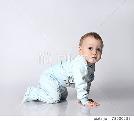 Sweet baby kid in bodysuite crawling, isolated 78600282