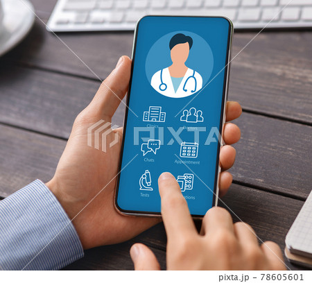 Man holding phone with online medical app on screen Man holding phone with online medical app on screen 78605601