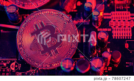 Bitcoin and semiconductor. Represent mining in Cryptocurrency cause global warming. Bitcoins on CPU board. Close-up Bitcoin with blue and pink light. circuit board with coin. Online asset concept. Bitcoin and semiconductor. Represent mining in Cryptocurrency cause global warming. Bitcoins on CPU board. Close-up Bitcoin with blue and pink light. circuit board with coin. Online asset concept. 78607247