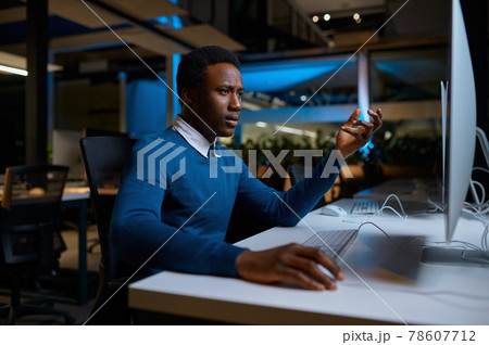 Man in glasses works on computer, office lifestyle Man in glasses works on computer, office lifestyle 78607712