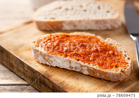 Sliced toast bread with sobrasada on rustic wooden table. Typical Mallorca food in Spain.	 78609475
