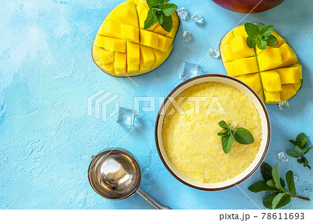 Ice cream, sweet snack or dessert. Homemade mango fruit ice cream, summer tropical fruit sorbet on a stone table. Top view flat lay background. Copy space. 78611693