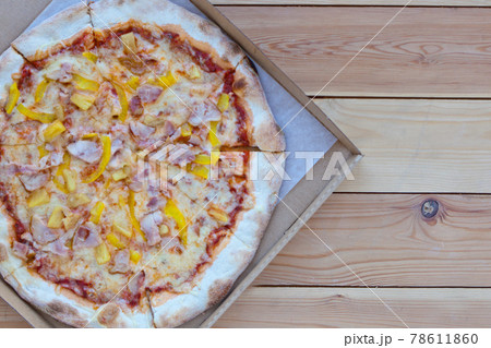 Pizza in a cardboard box on wooden background. Space for text. View from above. Pizza delivery. Pizza menu. Italian Pizza. Pizza Tonda Romana Pizza in a cardboard box on wooden background. Space for text. View from above. Pizza delivery. Pizza menu. Italian Pizza. Pizza Tonda Romana 78611860