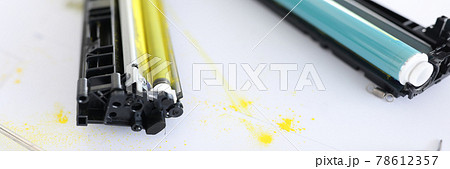 Yellow and blue cartridges for printer lying on table closeup Yellow and blue cartridges for printer lying on table closeup 78612357