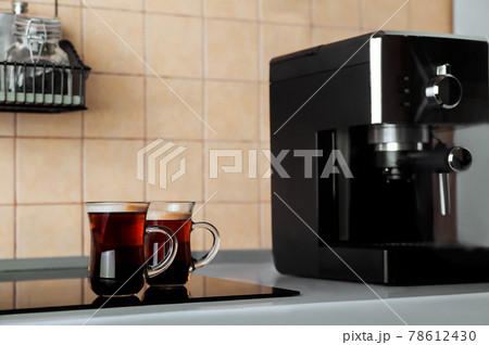 Two transparent cups coffee close-up front view. Home coffee maker and process of making coffee drink. Copy space. 78612430