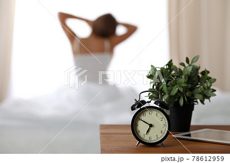 Woman stretching in bed after wake up, back view, entering a day happy and relaxed after good night sleep. Sweet dreams, good morning, new day, weekend, holidays concept 78612959
