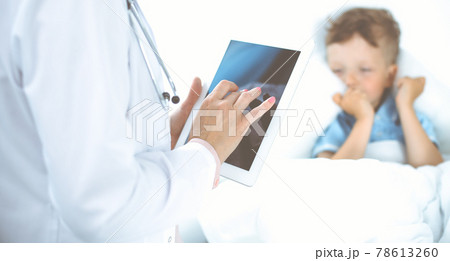 Happy smiling male kid-patient at usual medical inspection. Doctor and young boy in the clinic. Medicine concepts 78613260