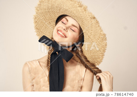 portrait of a romantic girl in a dress and a straw hat with a black ribbon emotions cropped view 78614740