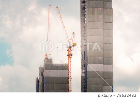 Skyscraper building construction. Crane working in construction site. Property and real estate development industry. Apartment building construction. Background for REIT fund. Building for rent. 78622432