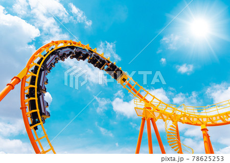 roller coaster high in the summer sky at theme park most excited fun and joyful playing machine 78625253