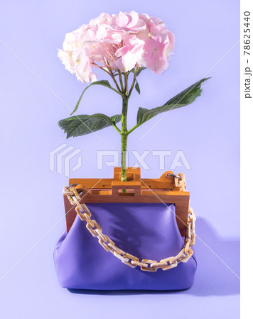 Purple leather fashion lady handbag with pink flower, summer accessory concept 78625440