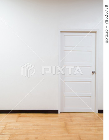 Empty interior with white wall, white door and wooden floor Empty interior with white wall, white door and wooden floor 78626759