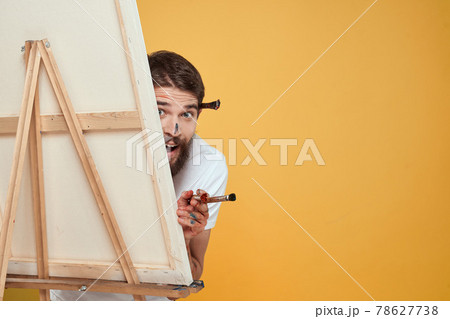 Male artist stands in front of easel emotions drawing Creative approach yellow 78627738