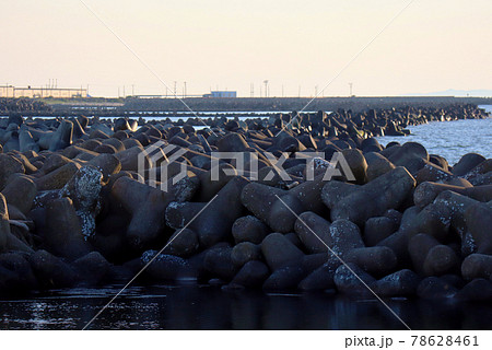 山の下船江町浜から臨む日本海と大量のテトラポット越しの夕焼け空 78628461