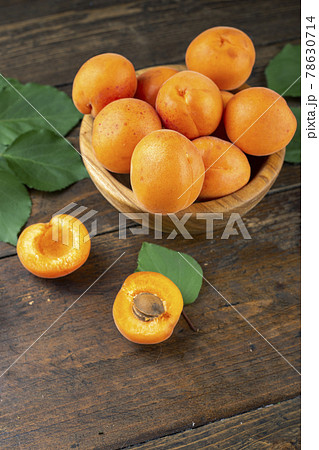 Delicious ripe apricots in a wooden bowl Delicious ripe apricots in a wooden bowl 78630714