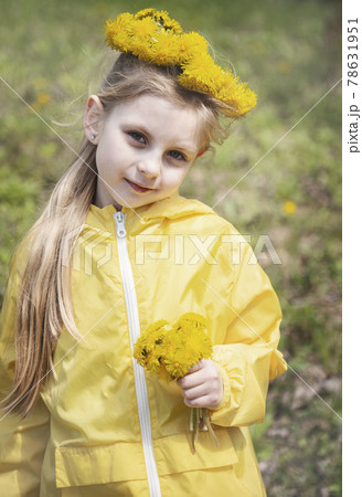 Little girl with a wreath of dandelions on her head Little girl with a wreath of dandelions on her head 78631951