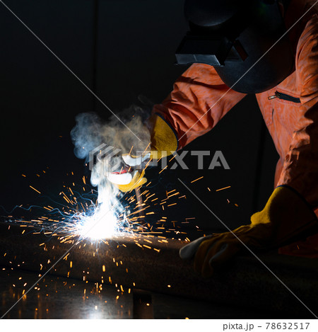 Metal industry workers are welding steel sheets for real estate projects received. Sparkler on black background, close-up. Heavy work in factory. Metal industry workers are welding steel sheets for real estate projects received. Sparkler on black background, close-up. Heavy work in factory. 78632517