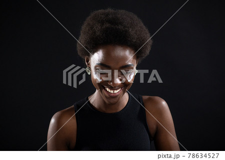 Beautiful young ethnic african american black woman applying moisturizer white cream on her face Beautiful young ethnic african american black woman applying moisturizer white cream on her face 78634527