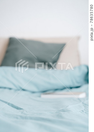 Blurred bed and pillows with book background 78635780