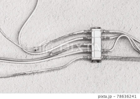 Antenna splitter on white wall, system with TV antenna cable splitter Antenna splitter on white wall, system with TV antenna cable splitter 78636241