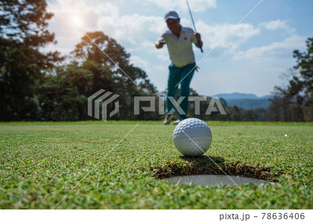 Blurred Golfers are putting golf in the evening golf course golf backglound Blurred Golfers are putting golf in the evening golf course golf backglound 78636406