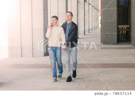 Gay couple walking in city centre, lifestyle Gay couple walking in city centre, lifestyle 78637114